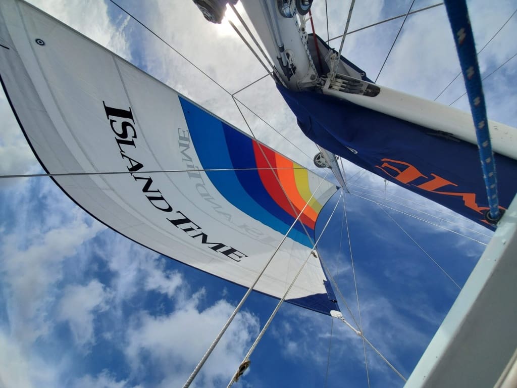 image of a low angle view of the sail on an Island Time Sailing boat