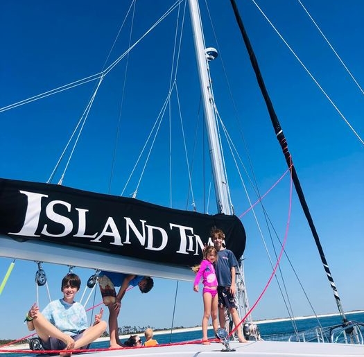 Happy sailors about the Island Time II sailing catamaran at Island Time Sailing.