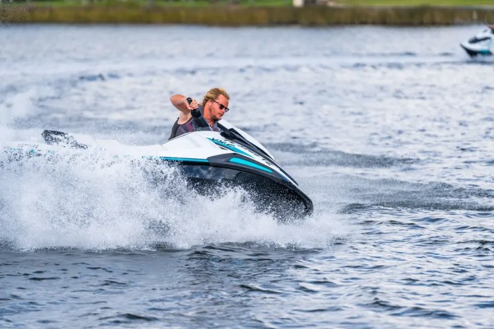 Person riding a jet ski swiftly across the water.