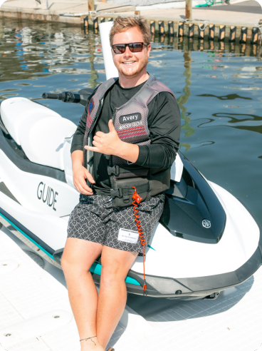 a person standing next to a body of water
