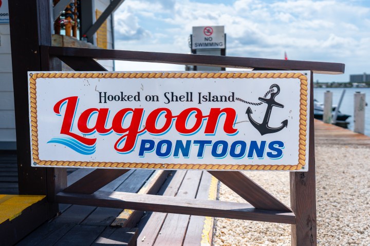 Sign for Lagoon Pontoons with anchor design, sunny weather.