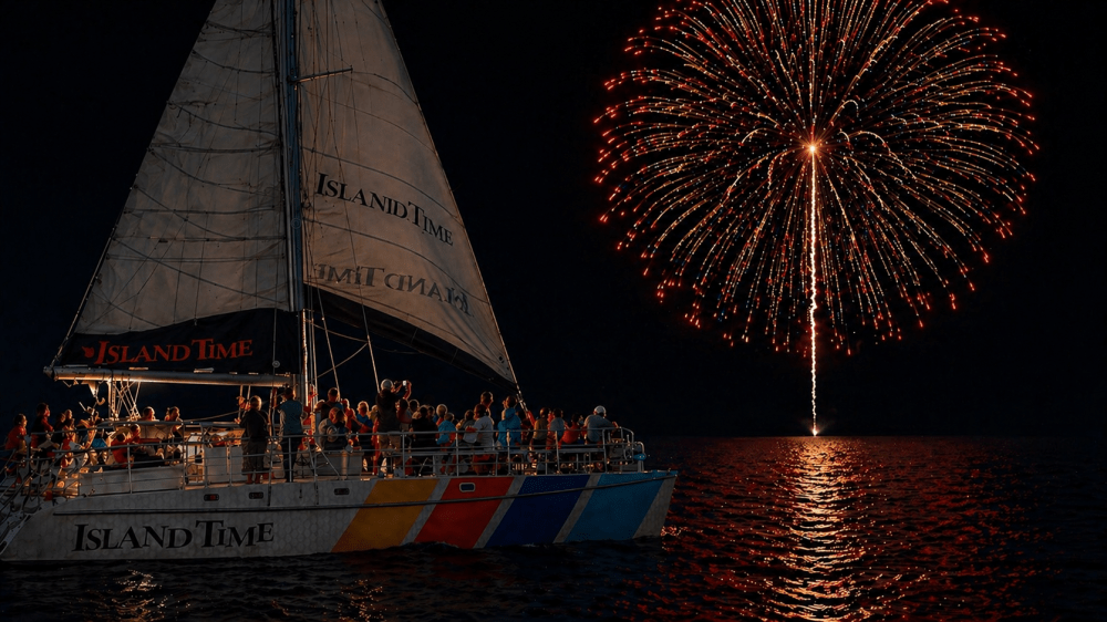 Large fireworks over water with sailboat named 'Island Time' and passengers on board.