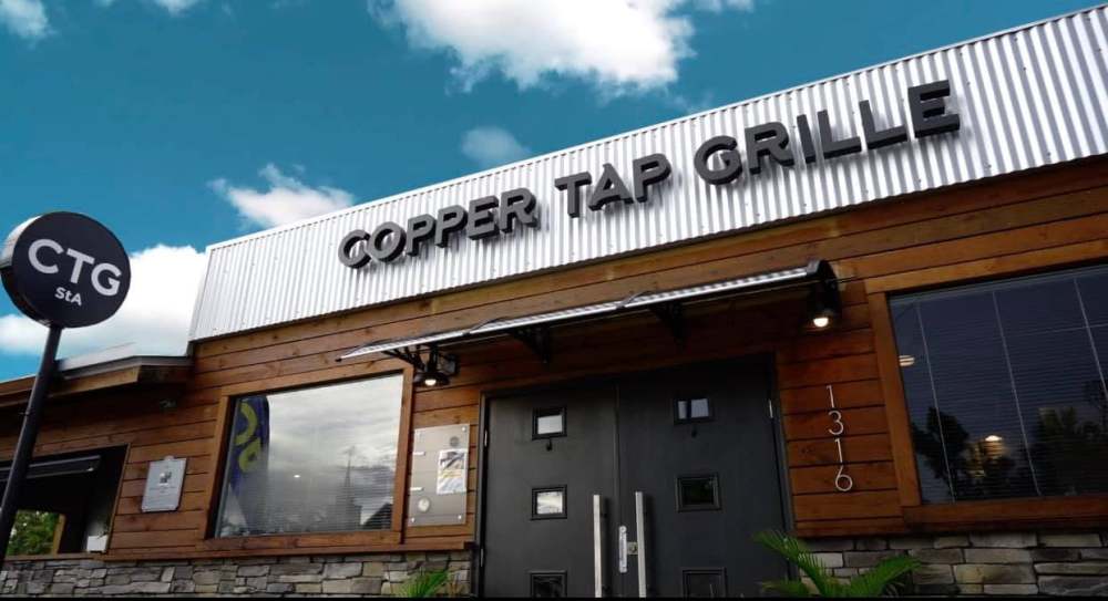 Copper Tap Grille building with metal and wood facade, CTG sign.